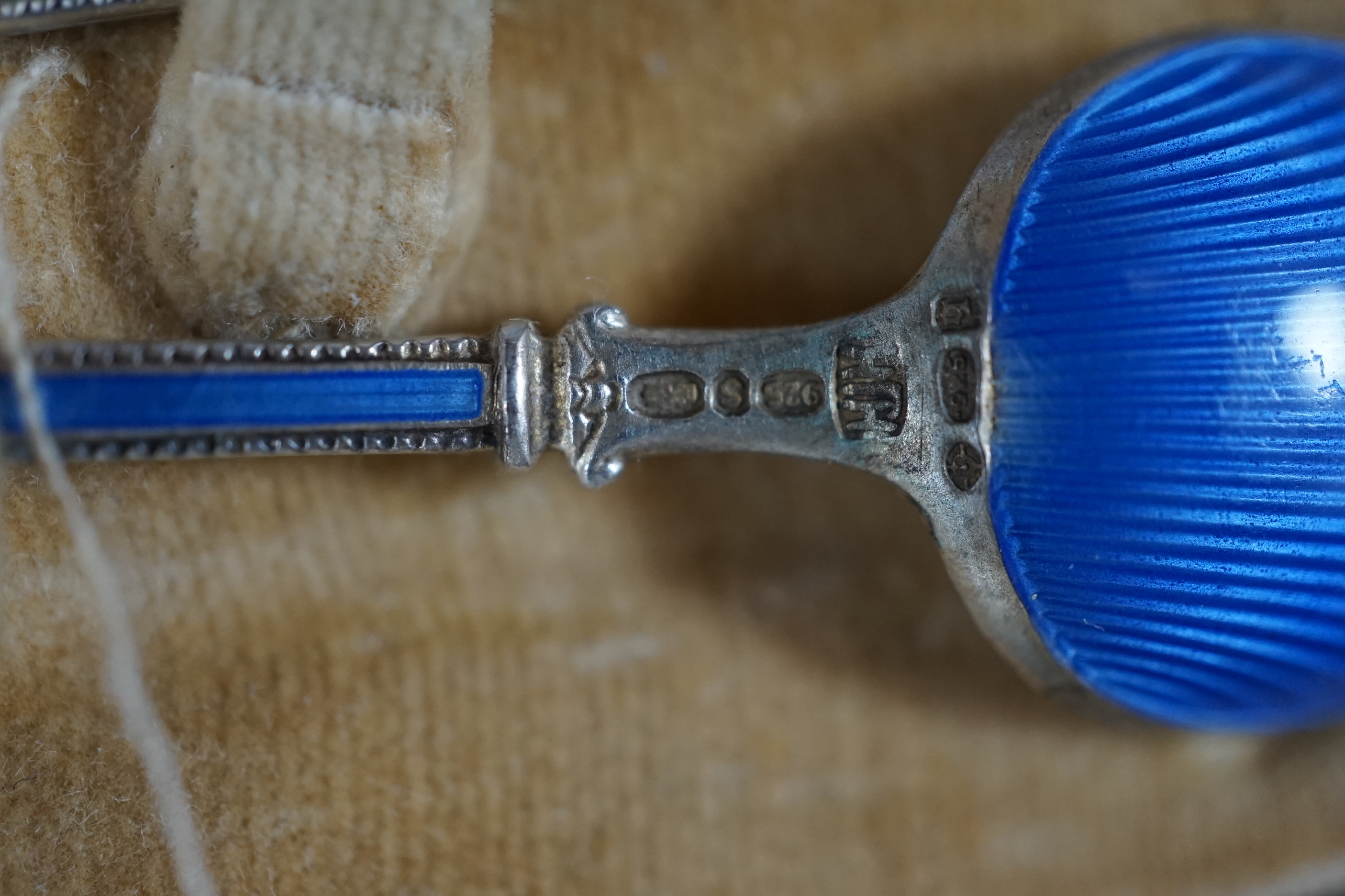 A cased Worcester powder blue and silvered coffee set with enamelled silver spoons together with a cased set of six green and frosted glass salts